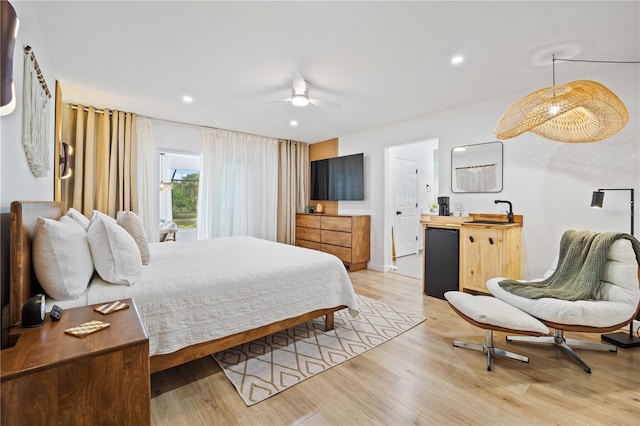 bedroom featuring ceiling fan, light wood-style flooring, recessed lighting, refrigerator, and a sink