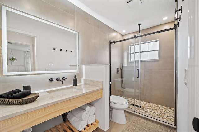 full bathroom with toilet, a shower stall, visible vents, and vanity