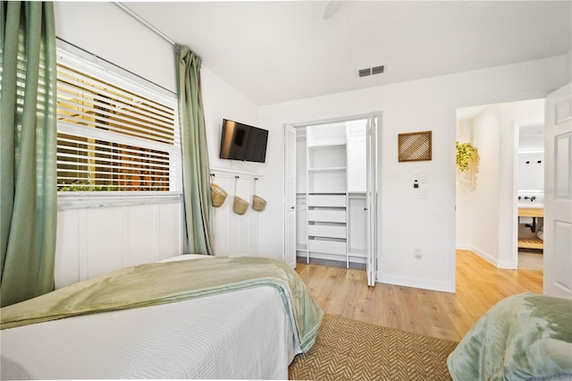 bedroom with visible vents, baseboards, a ceiling fan, light wood-style flooring, and a closet