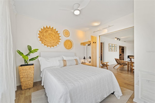 bedroom with light wood-style flooring and a ceiling fan