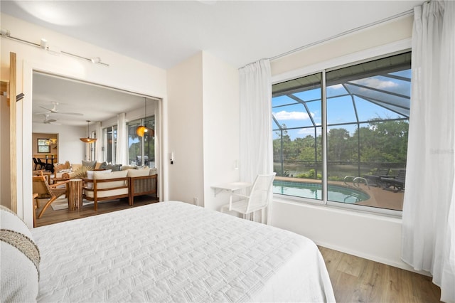 bedroom featuring a sunroom and wood finished floors