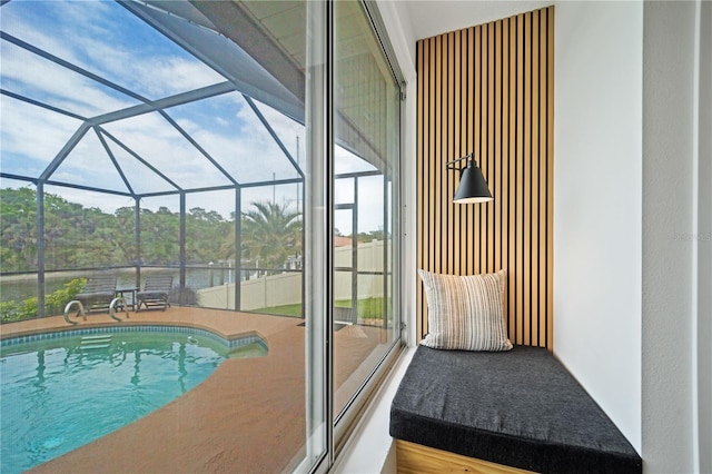 outdoor pool with glass enclosure and a patio