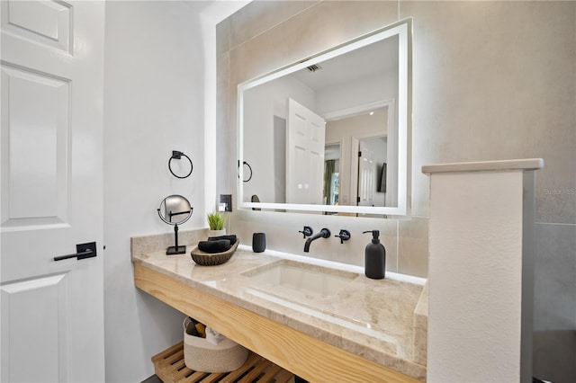 bathroom with visible vents and a sink