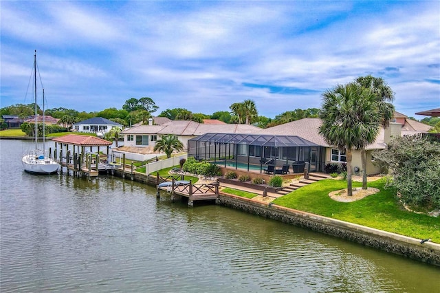 view of dock with an outdoor pool, glass enclosure, boat lift, a water view, and a yard