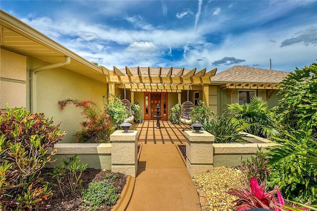 85 Comanche Ct, Palm Coast, FL 32137 - doorway to property with stucco siding, a pergola, and roof with shingles