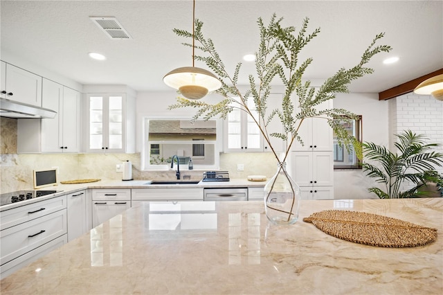 85 Comanche Ct, Palm Coast, FL 32137 - kitchen featuring a sink, black electric cooktop, decorative backsplash, white cabinetry, and recessed lighting