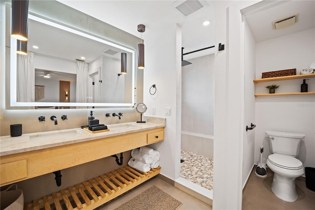 85 Comanche Ct, Palm Coast, FL 32137 - bathroom featuring a walk in shower, double vanity, toilet, and baseboards