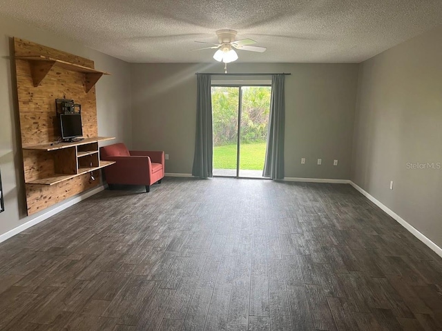 unfurnished living room featuring a ceiling fan, a textured ceiling, baseboards, and dark wood-type flooring