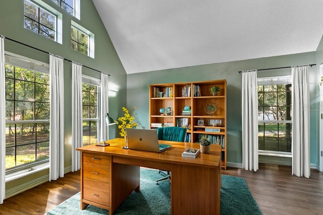 home office with dark wood-style floors, high vaulted ceiling, and a wealth of natural light