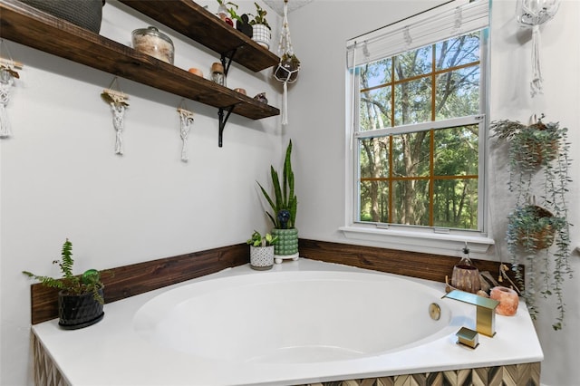 full bath featuring a tub to relax in and a wealth of natural light