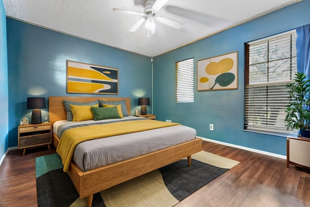 bedroom with dark wood-style floors, ceiling fan, and baseboards