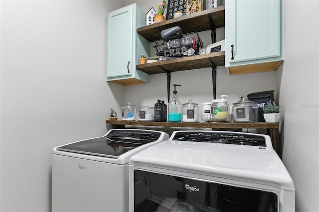 laundry area with washing machine and dryer and cabinet space