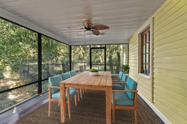 unfurnished sunroom featuring a ceiling fan