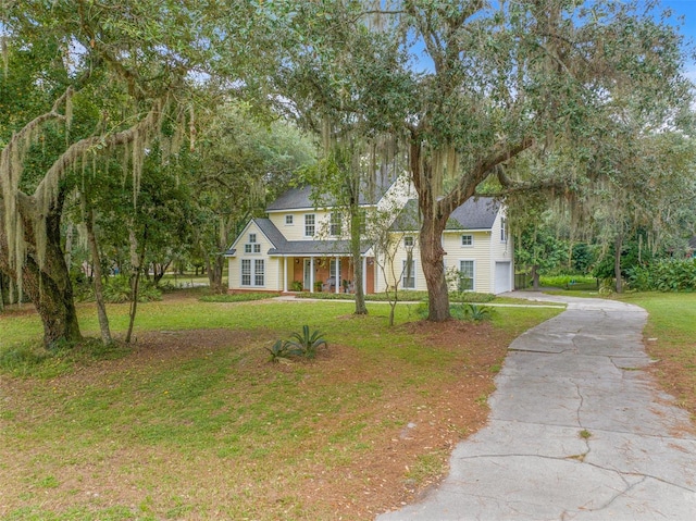 view of front of property with a garage, driveway, and a front lawn