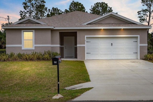 ranch-style house with a garage, driveway, a lawn, roof with shingles, and stucco siding