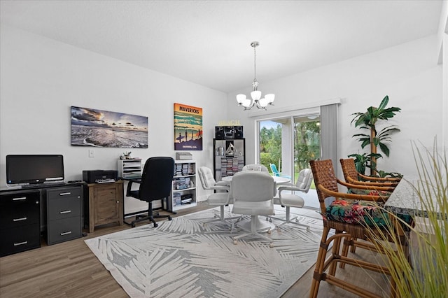 home office featuring a notable chandelier and wood finished floors