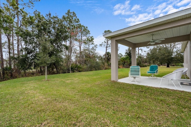 view of yard featuring a patio area and ceiling fan