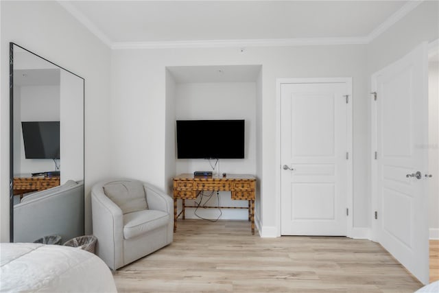 bedroom with ornamental molding, light wood-style flooring, and baseboards