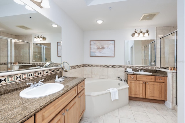 bathroom with a shower stall, visible vents, and a sink