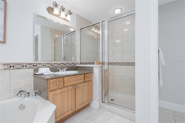 bathroom with a stall shower, a garden tub, and vanity