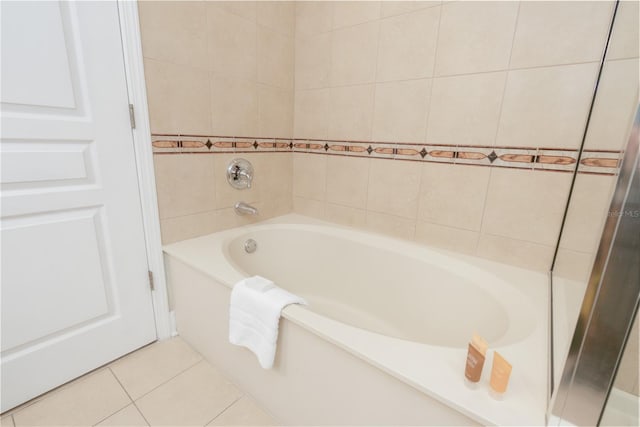 full bathroom with a tub to relax in and tile patterned floors