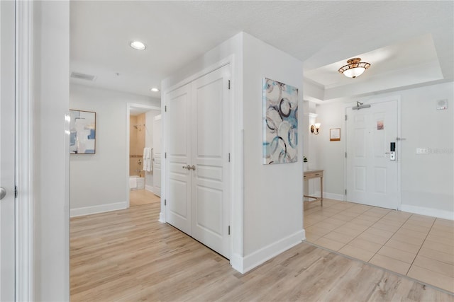 interior space featuring light wood finished floors, visible vents, baseboards, and recessed lighting