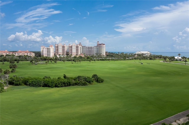 view of property's community featuring view of golf course, a city view, and a water view