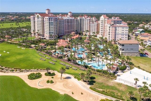 birds eye view of property featuring view of golf course and a city view