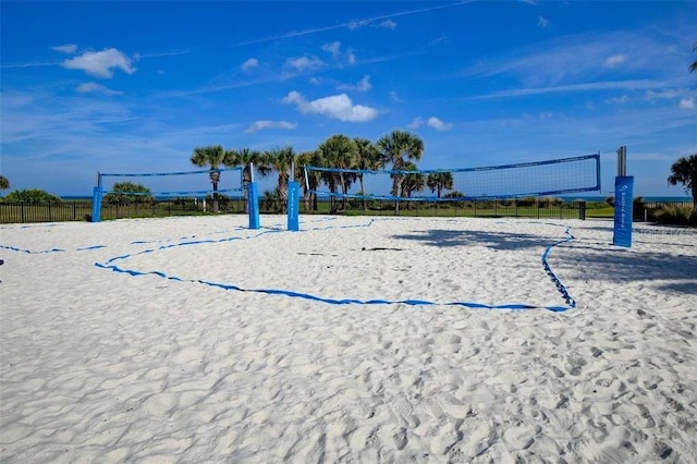 view of community featuring fence and volleyball court