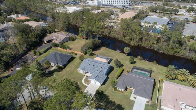 drone / aerial view with a water view and a residential view