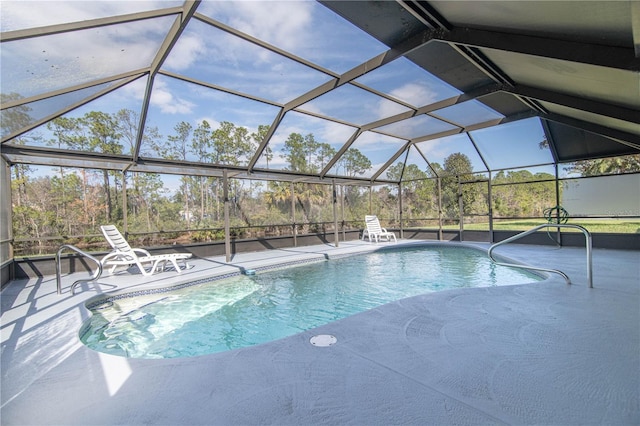 pool with glass enclosure and a patio