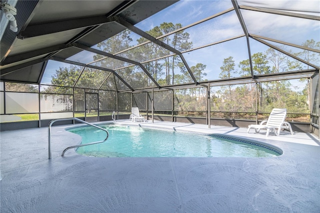 outdoor pool with a lanai and a patio