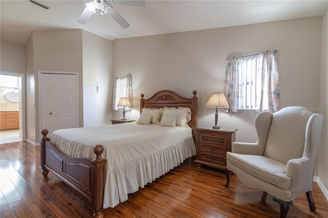 bedroom with ceiling fan, a closet, dark wood finished floors, and visible vents