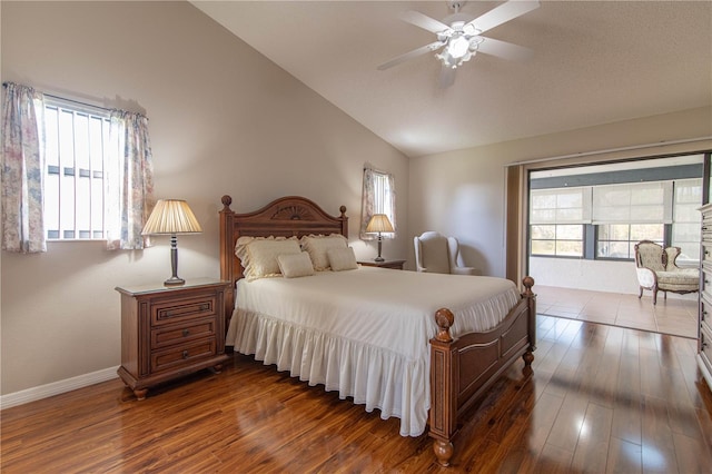 bedroom featuring vaulted ceiling, dark wood-type flooring, multiple windows, and baseboards