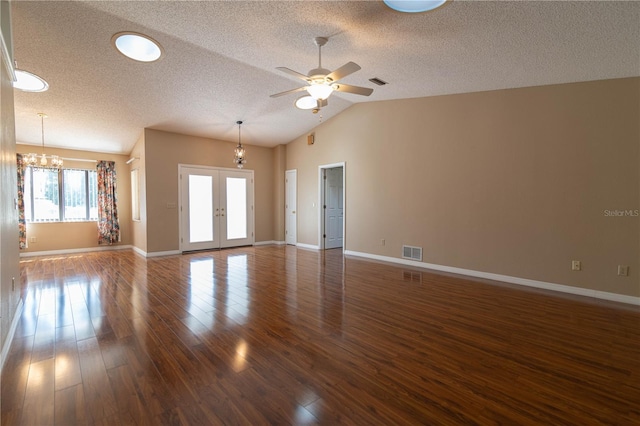 unfurnished living room with french doors, visible vents, dark wood-style flooring, and ceiling fan with notable chandelier