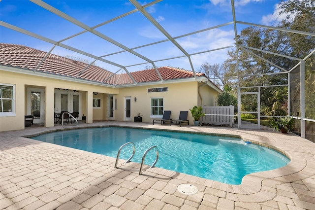 outdoor pool featuring french doors, a patio area, and a lanai