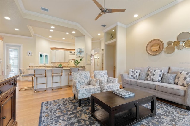 living room featuring ceiling fan, light wood-style flooring, and recessed lighting