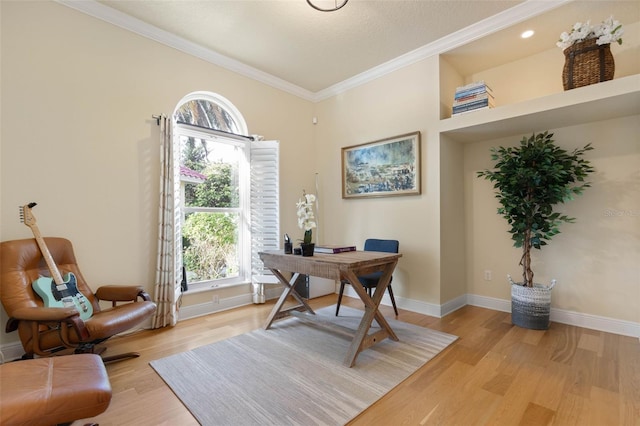 home office with light wood-type flooring, baseboards, and ornamental molding