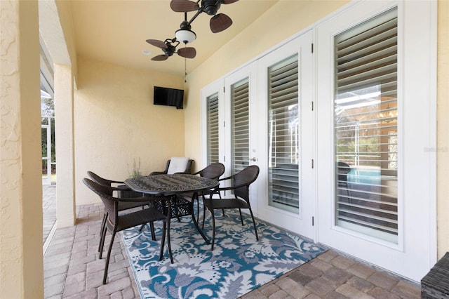 view of patio / terrace featuring french doors, outdoor dining space, and a ceiling fan