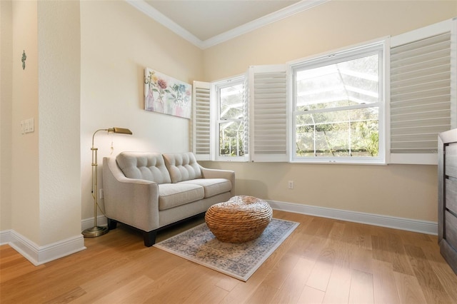 living area featuring light wood-type flooring, baseboards, and ornamental molding