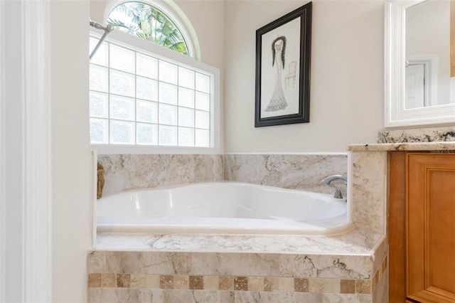 full bath with a bath, a wealth of natural light, and vanity