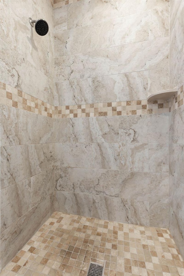 details with visible vents and a tile shower