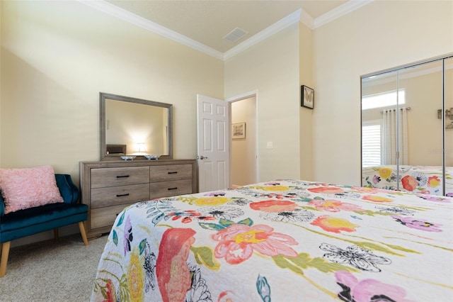 bedroom with a closet, carpet flooring, visible vents, and crown molding