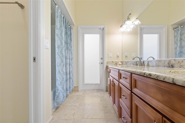 full bath featuring tile patterned floors, shower / bath combination with curtain, and vanity