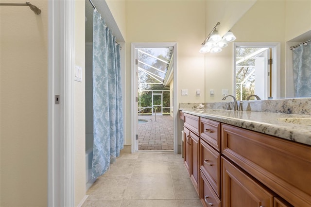 bathroom with shower / tub combo, vanity, and tile patterned floors