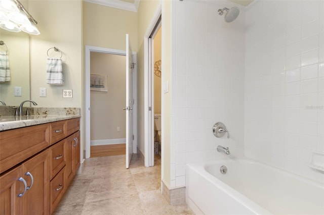 bathroom with crown molding, toilet, vanity, baseboards, and tile patterned floors