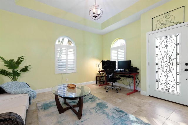 office with baseboards, a tray ceiling, and tile patterned flooring