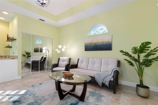 living area with light tile patterned floors, baseboards, visible vents, and recessed lighting