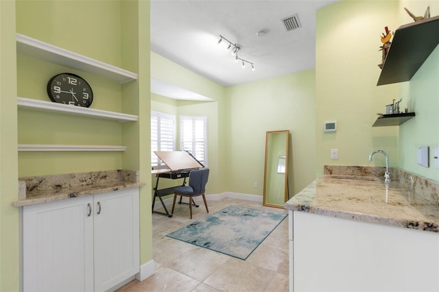 kitchen featuring light tile patterned floors, a sink, visible vents, light stone countertops, and open shelves