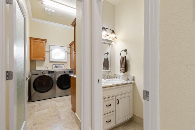 bathroom with ornamental molding, separate washer and dryer, and vanity